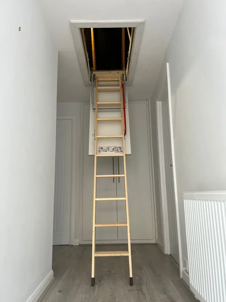 Wooden loft ladder fitted in a hallway